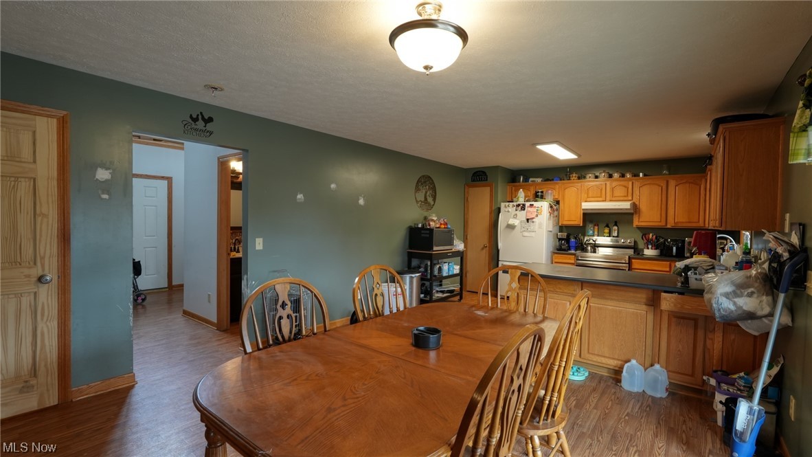 3752 Holmes Road Cambridge, OH 43725 - Photo 11 of 50 Dining area with dark hardwood / wood-style flooring and a textured ceiling