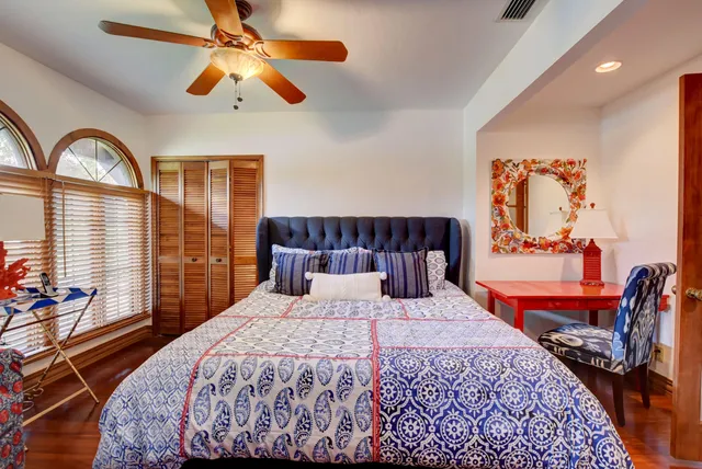 a bedroom with a bed and a large window