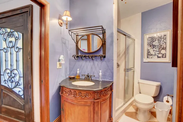 a bathroom with a sink a toilet and a mirror