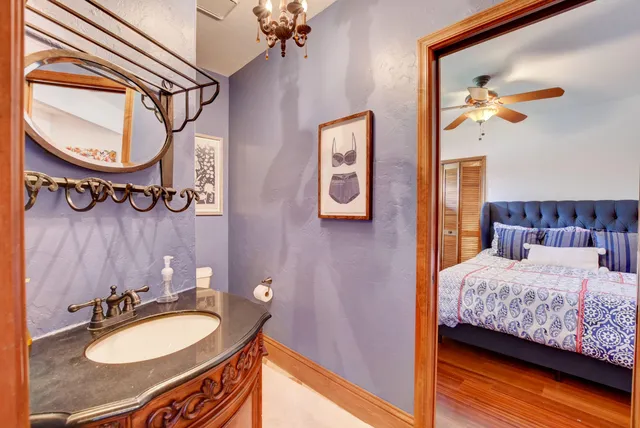 a bedroom with a bed dresser and a dining table