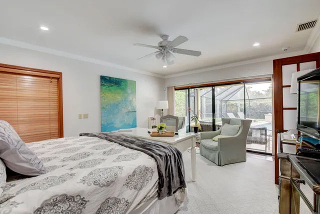 a bedroom with furniture and large windows