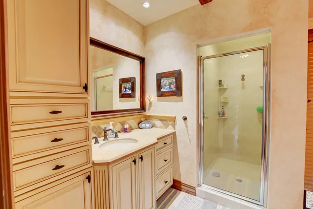 a bathroom with a sink a mirror and a shower