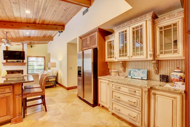 a kitchen with stainless steel appliances kitchen island granite countertop a stove and a refrigerator
