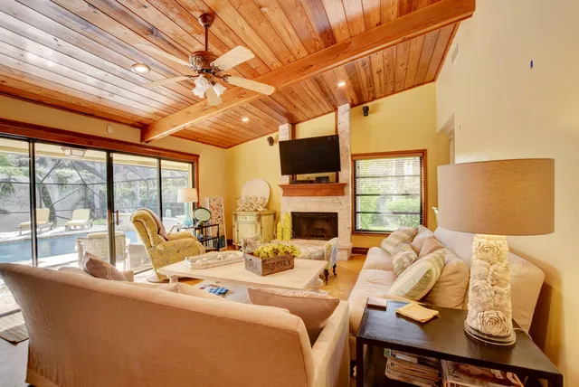 a living room with fireplace furniture and a flat screen tv