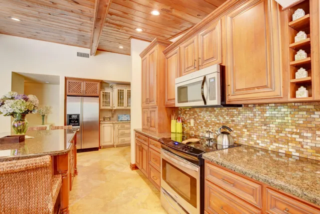 a kitchen with stainless steel appliances granite countertop a sink and cabinets