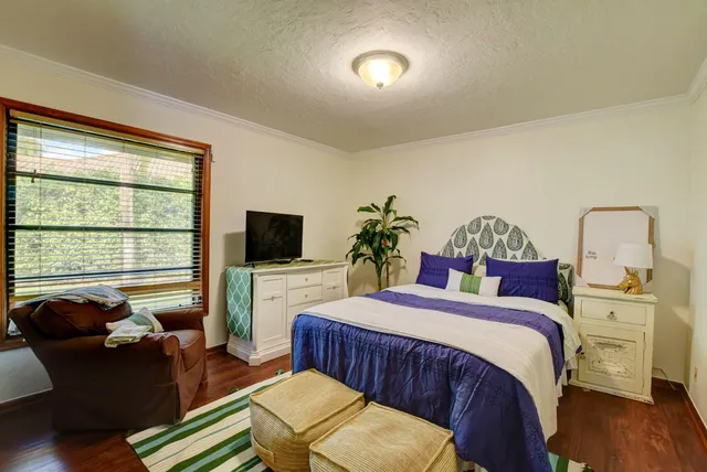 a bedroom with a bed and a flat screen tv