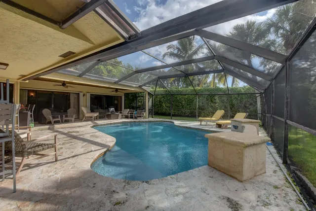 a view of a backyard with sitting area