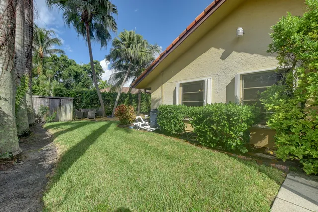 a front view of house with a garden