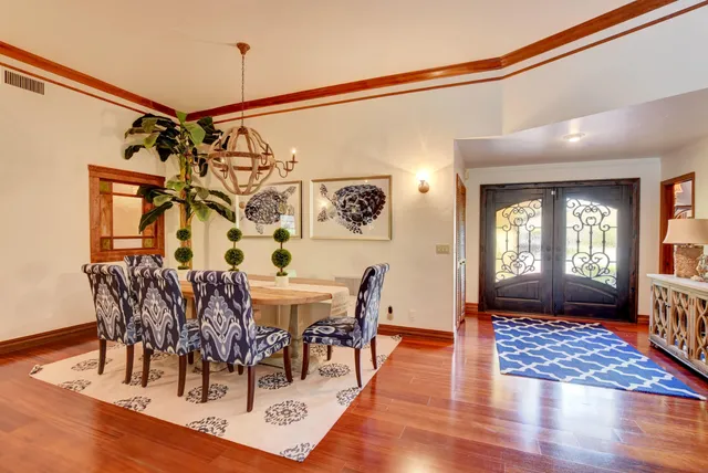 a view of a dining room with furniture and wooden floor