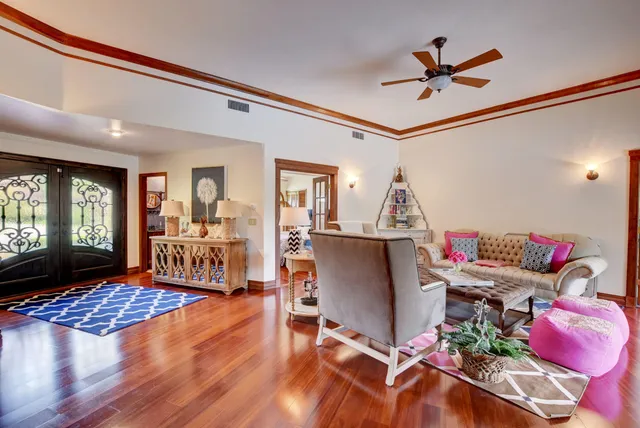 a living room with furniture and wooden floor