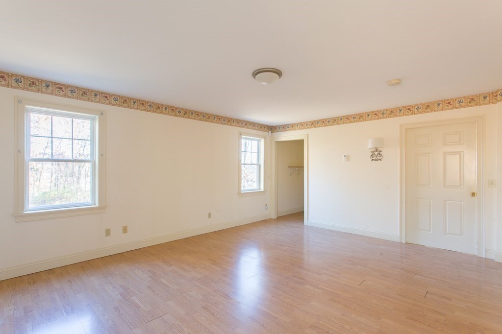 76 Davis Road New Braintree, MA 01531 - Photo 11 of 40 a view of an empty room with wooden floor and a window