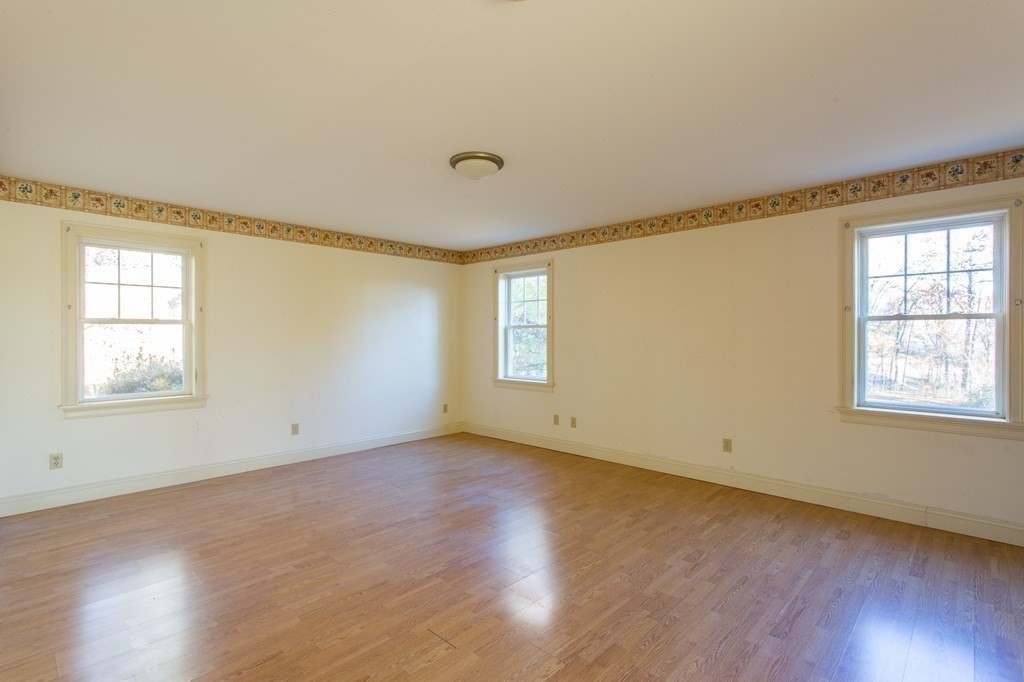 76 Davis Road New Braintree, MA 01531 - Photo 12 of 40 a view of an empty room with wooden floor and a window