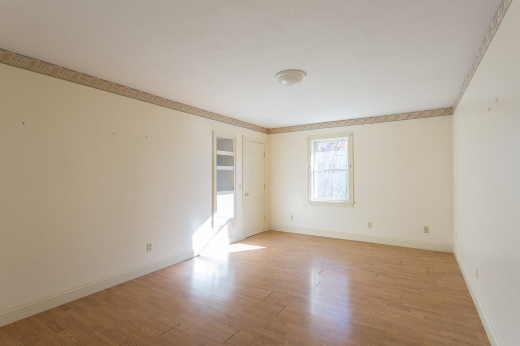 76 Davis Road New Braintree, MA 01531 - Photo 23 of 40 an empty room with wooden floor and windows