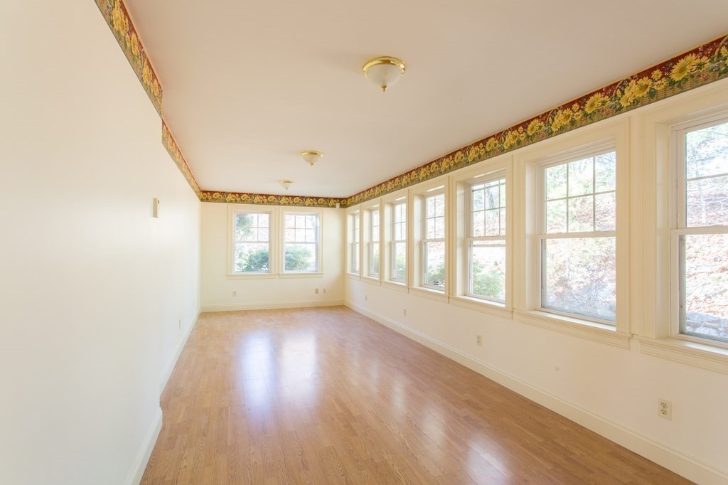 76 Davis Road New Braintree, MA 01531 - Photo 5 of 40 a view of an empty room with wooden floor and a window