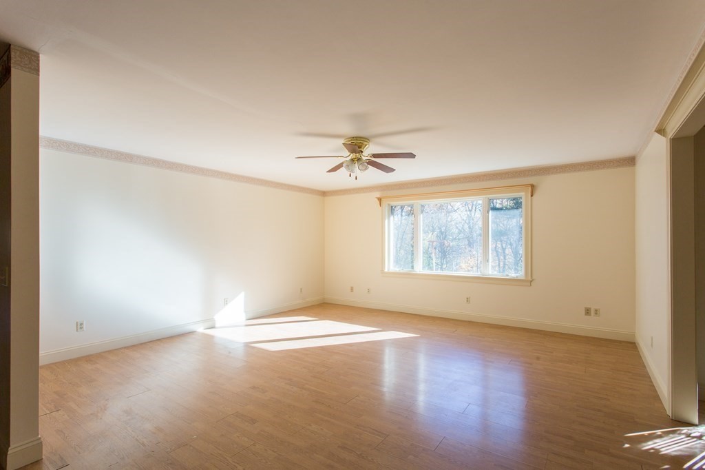 76 Davis Road New Braintree, MA 01531 - Photo 8 of 40 an empty room with a window and a ceiling fan