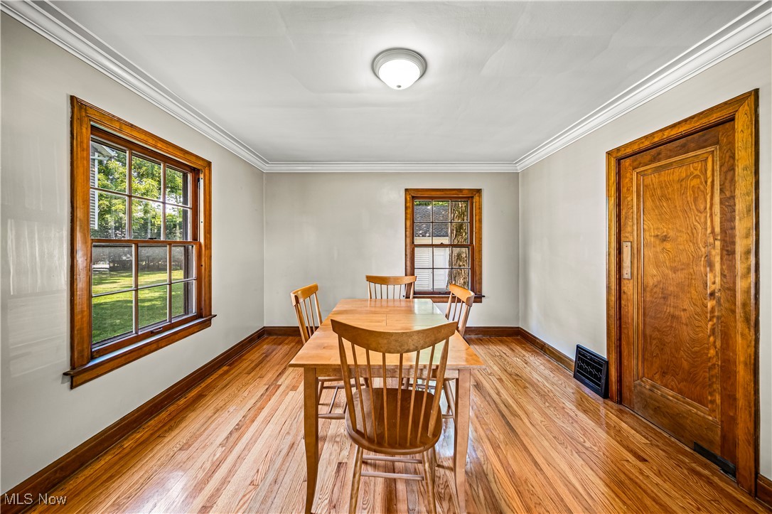 8219 Midland Road Mentor, OH 44060 - Photo 11 of 34 Dining area featuring crown molding and light hardwood / wood-style floors