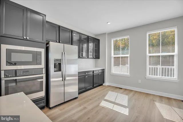 a kitchen with stainless steel appliances granite countertop a refrigerator and a sink