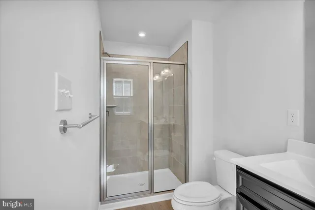 a bathroom with a shower a toilet and a sink