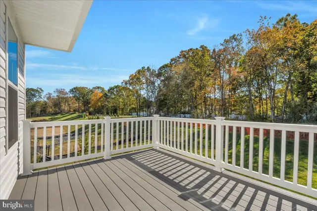 a view of balcony with wooden floor and fence