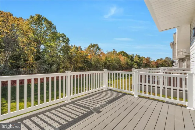 a view of balcony with wooden floor and fence