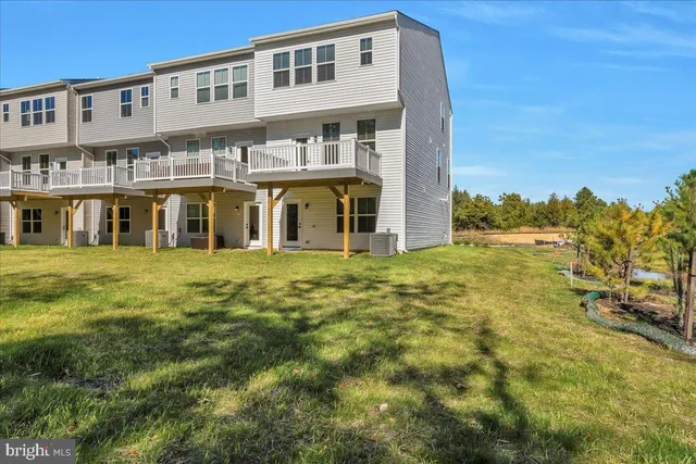 a front view of residential houses with yard