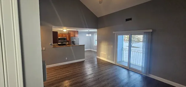 a view of a kitchen with wooden floor and a kitchen