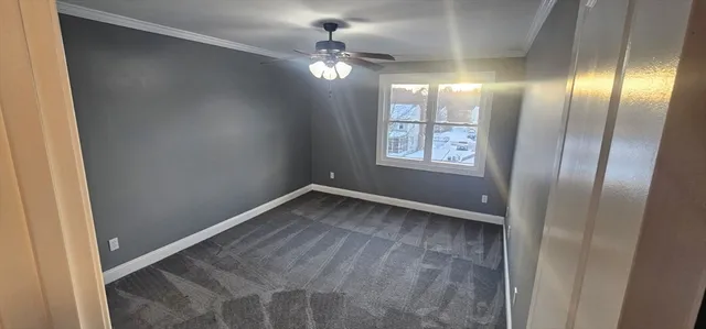 a view of an empty room with a fan