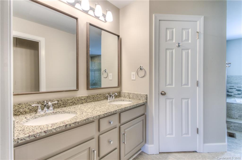 9827 Withers Road Charlotte, NC 28278 - Photo 11 of 24 a bathroom with a granite countertop double vanity sink and a mirror