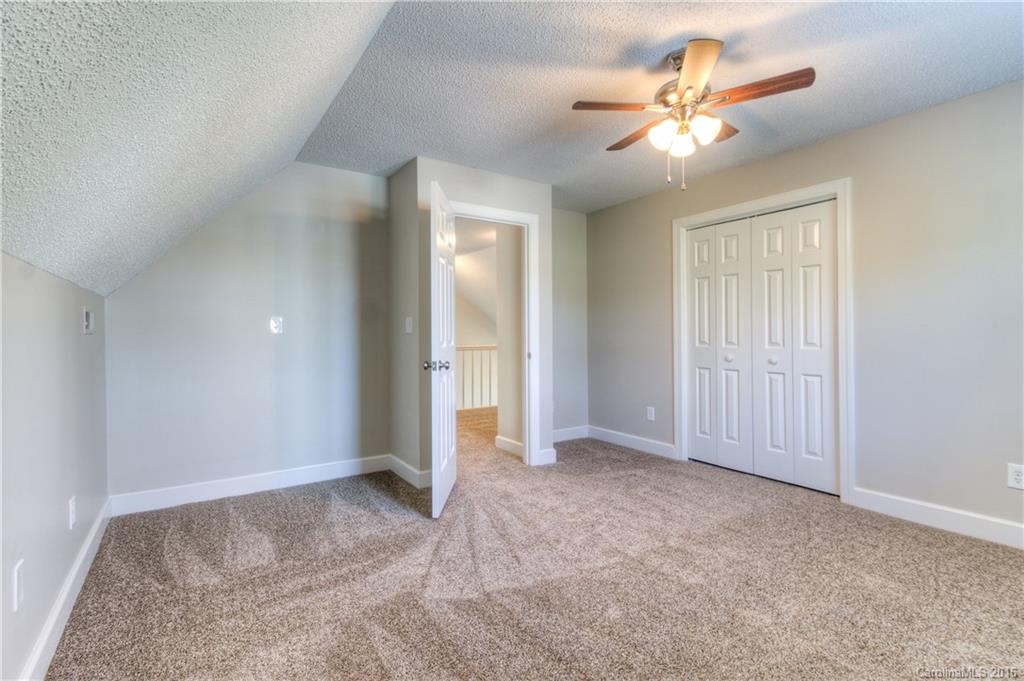 9827 Withers Road Charlotte, NC 28278 - Photo 14 of 24 an empty room with fan and a ceiling fan