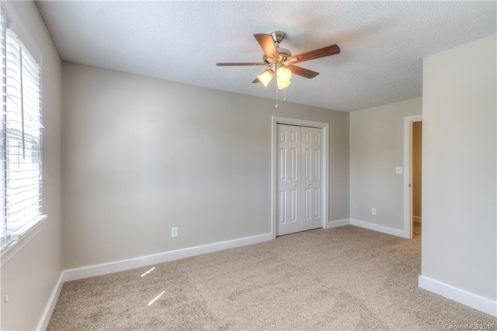 9827 Withers Road Charlotte, NC 28278 - Photo 15 of 24 an empty room with windows and fan