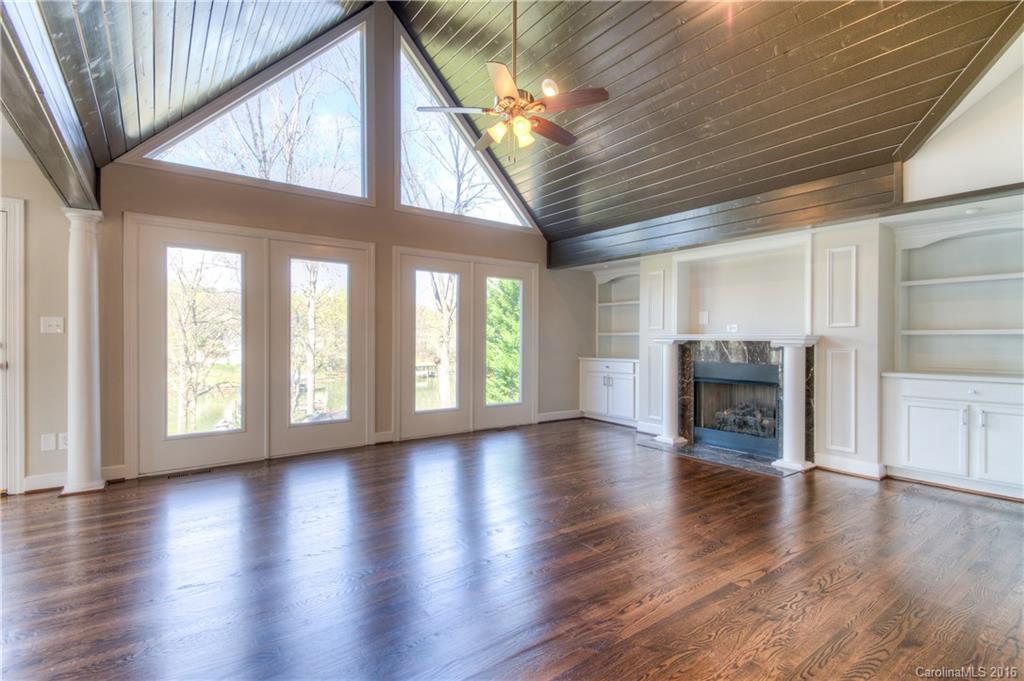 9827 Withers Road Charlotte, NC 28278 - Photo 3 of 24 a view of an empty room with wooden floor and a window