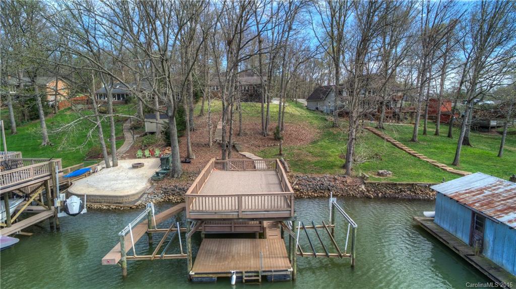 9827 Withers Road Charlotte, NC 28278 - Photo 23 of 24 a wooden bench sitting next to a lake