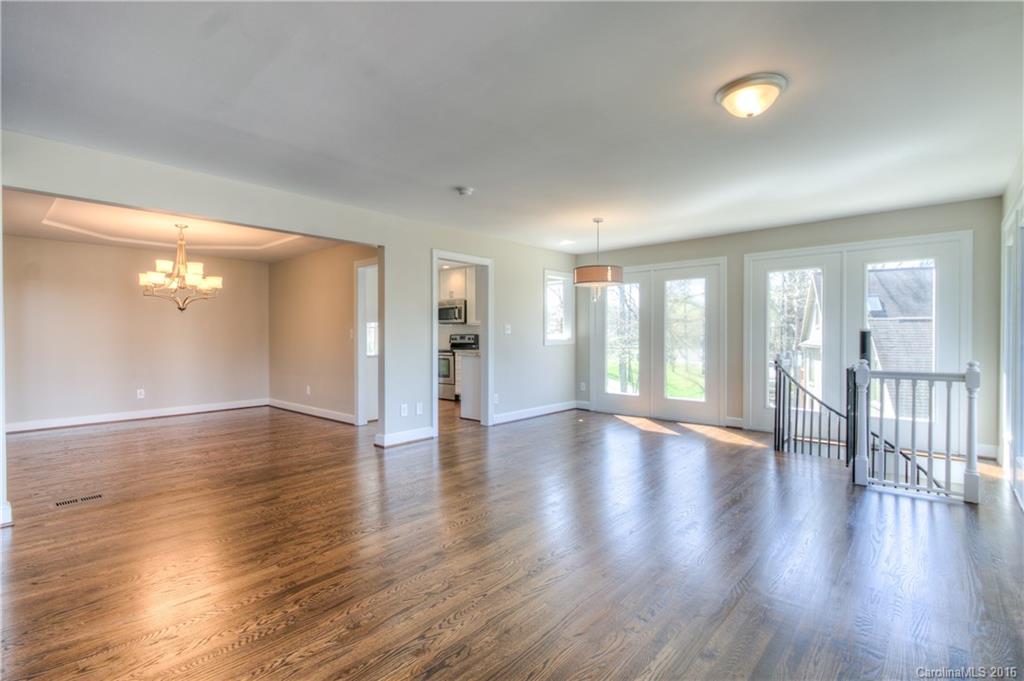 9827 Withers Road Charlotte, NC 28278 - Photo 4 of 24 a view of an empty room with wooden floor and a window