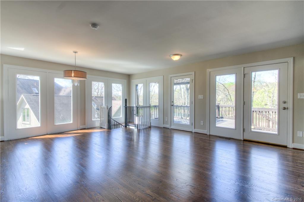 9827 Withers Road Charlotte, NC 28278 - Photo 5 of 24 a view of an empty room with wooden floor and a floor to ceiling window