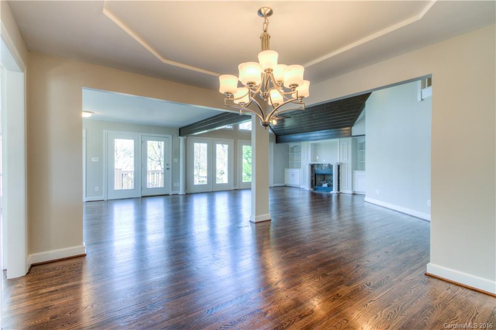 9827 Withers Road Charlotte, NC 28278 - Photo 6 of 24 a view of a room with wooden floor chandelier and windows