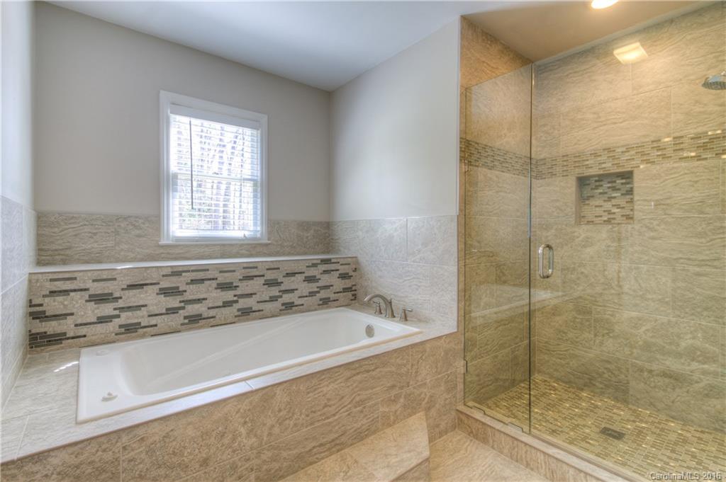 9827 Withers Road Charlotte, NC 28278 - Photo 10 of 24 a bathroom with a bathtub and shower