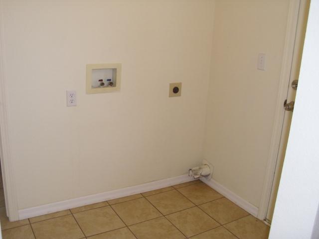 16138 Karen Road Madera, CA 93636 - Photo 9 of 11 Laundry room/mud room with exit door to rear of home, connects to kitchen and hall bath.