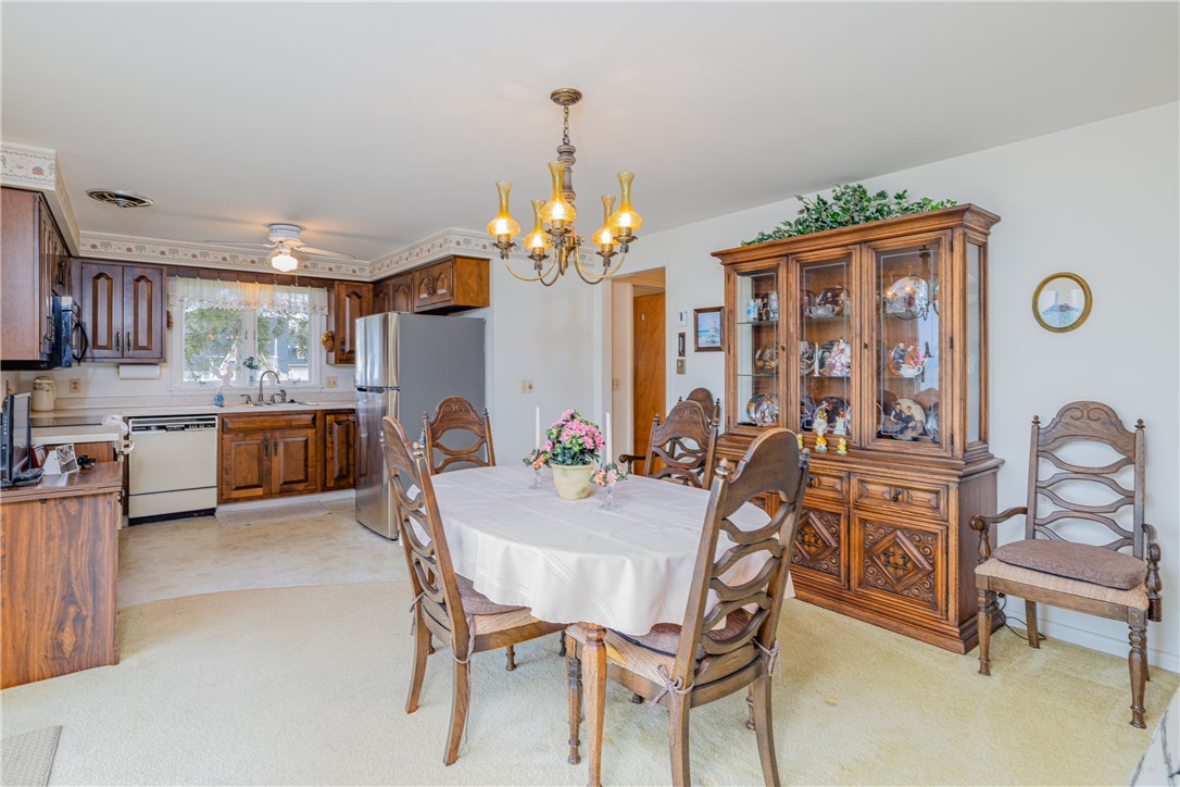 12 Lighthouse Road Parma, NY 14468 - Photo 11 of 49 Quality hardwood cabinets in this country kitchen. Open to the dining area with 8 foot sliding glass door to concrete patio.