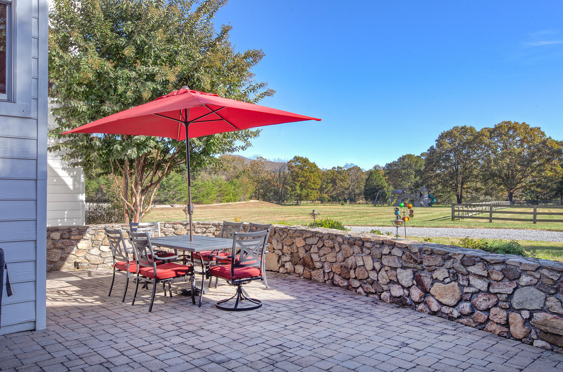 1413 Pollard Road Montvale, VA 24122 - Photo 10 of 68 a view of a swimming pool with a table and chairs under an umbrella
