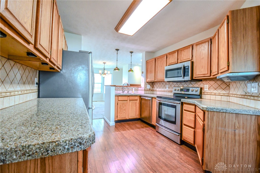3915 East Summit Ridge Drive Beavercreek, OH 45430 - Photo 14 of 47 This spacious kitchen offers ample counter space and modern appliances, perfect for everyday living.