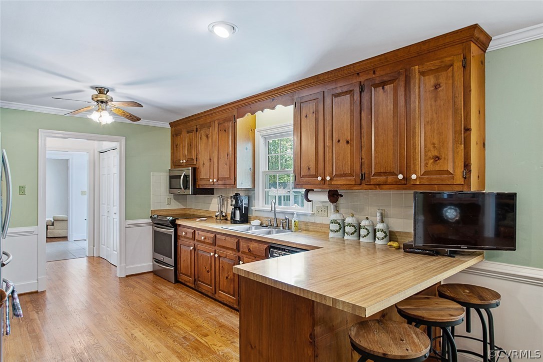 6611 Glebe Point Road Chesterfield, VA 23838 - Photo 13 of 44 a kitchen with wooden cabinets a sink a stove and a refrigerator