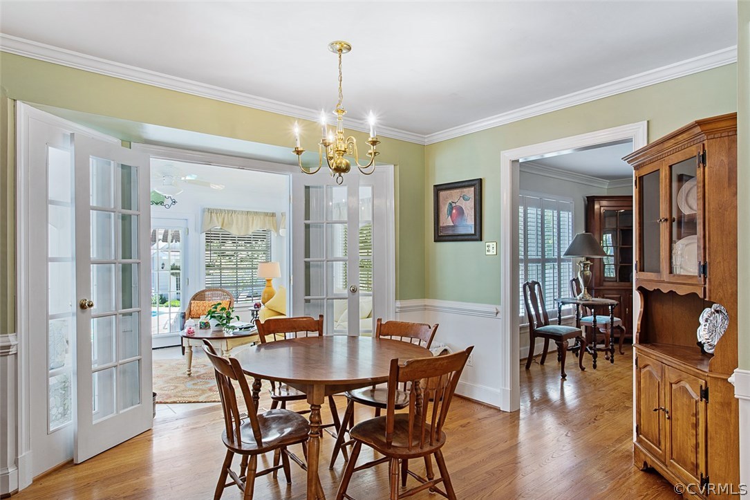 6611 Glebe Point Road Chesterfield, VA 23838 - Photo 16 of 44 a view of a dining room with furniture wooden floor and chandelier
