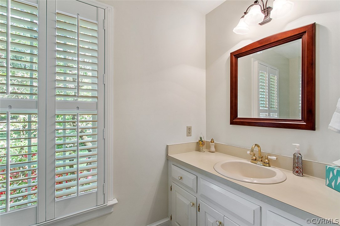 6611 Glebe Point Road Chesterfield, VA 23838 - Photo 21 of 44 a bathroom with a toilet a sink a vanity and a mirror