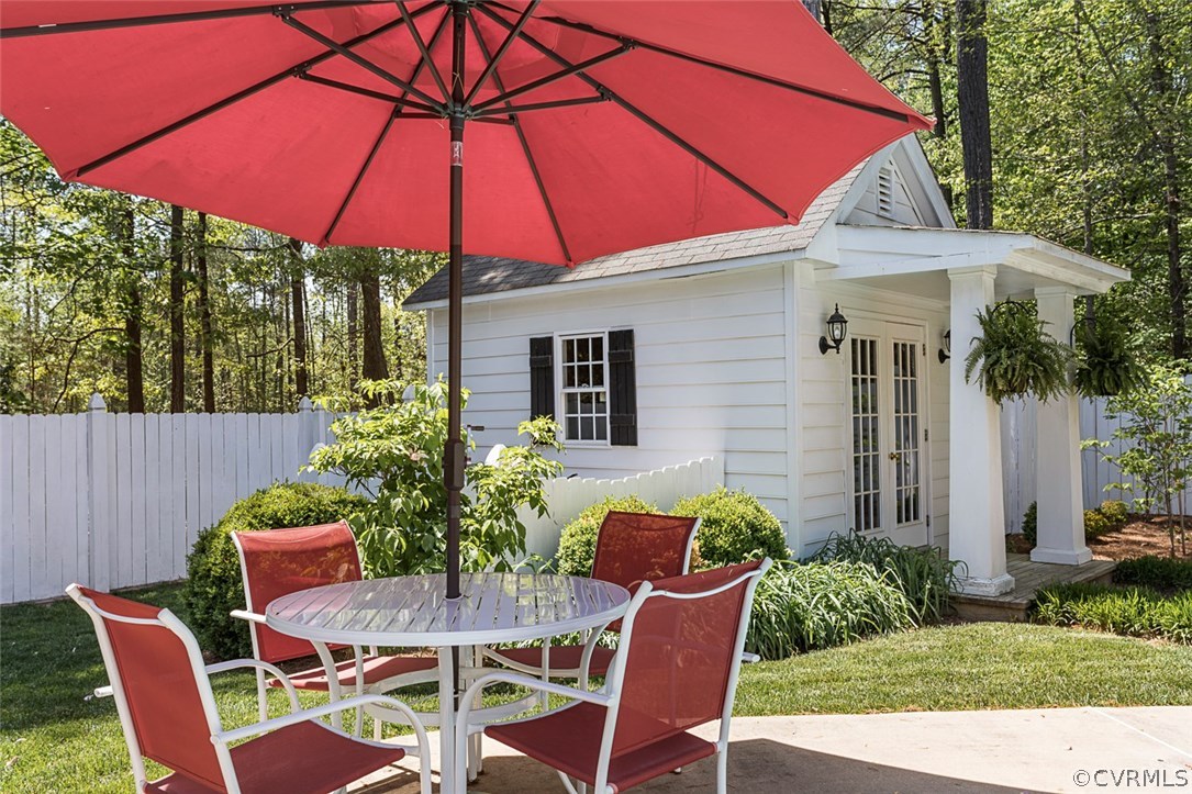 6611 Glebe Point Road Chesterfield, VA 23838 - Photo 35 of 44 a patio with a table and chairs under an umbrella