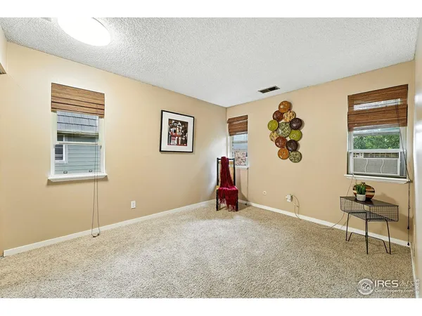 a view of an empty room with window and workspace