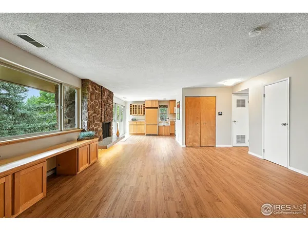 a big room with wooden floor and windows