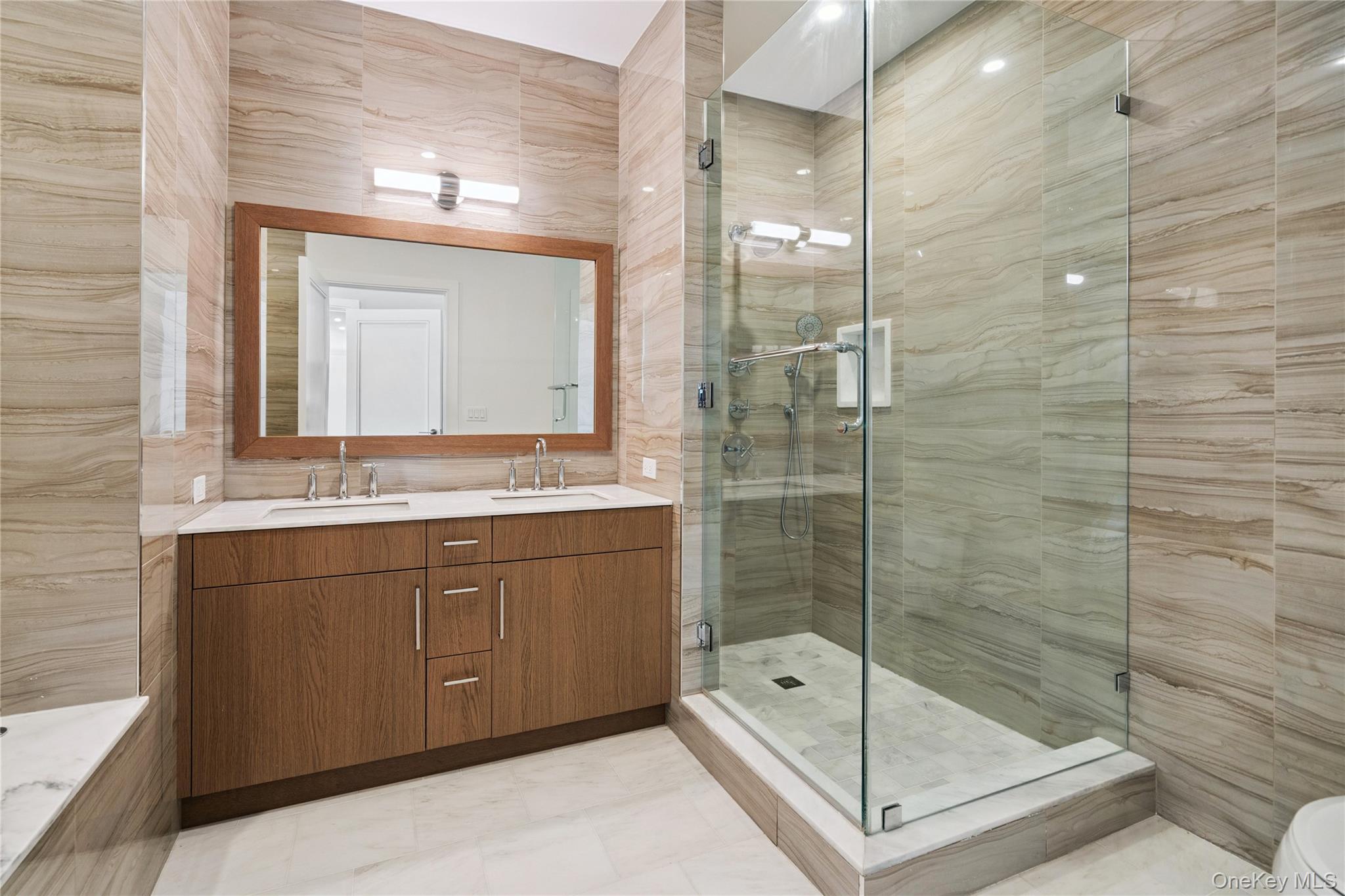 100 Garvies Point Road, Unit 1304 Glen Cove, NY 11542 - Photo 14 of 34 Primary Bathroom featuring a stall shower, separate tub and double vanity