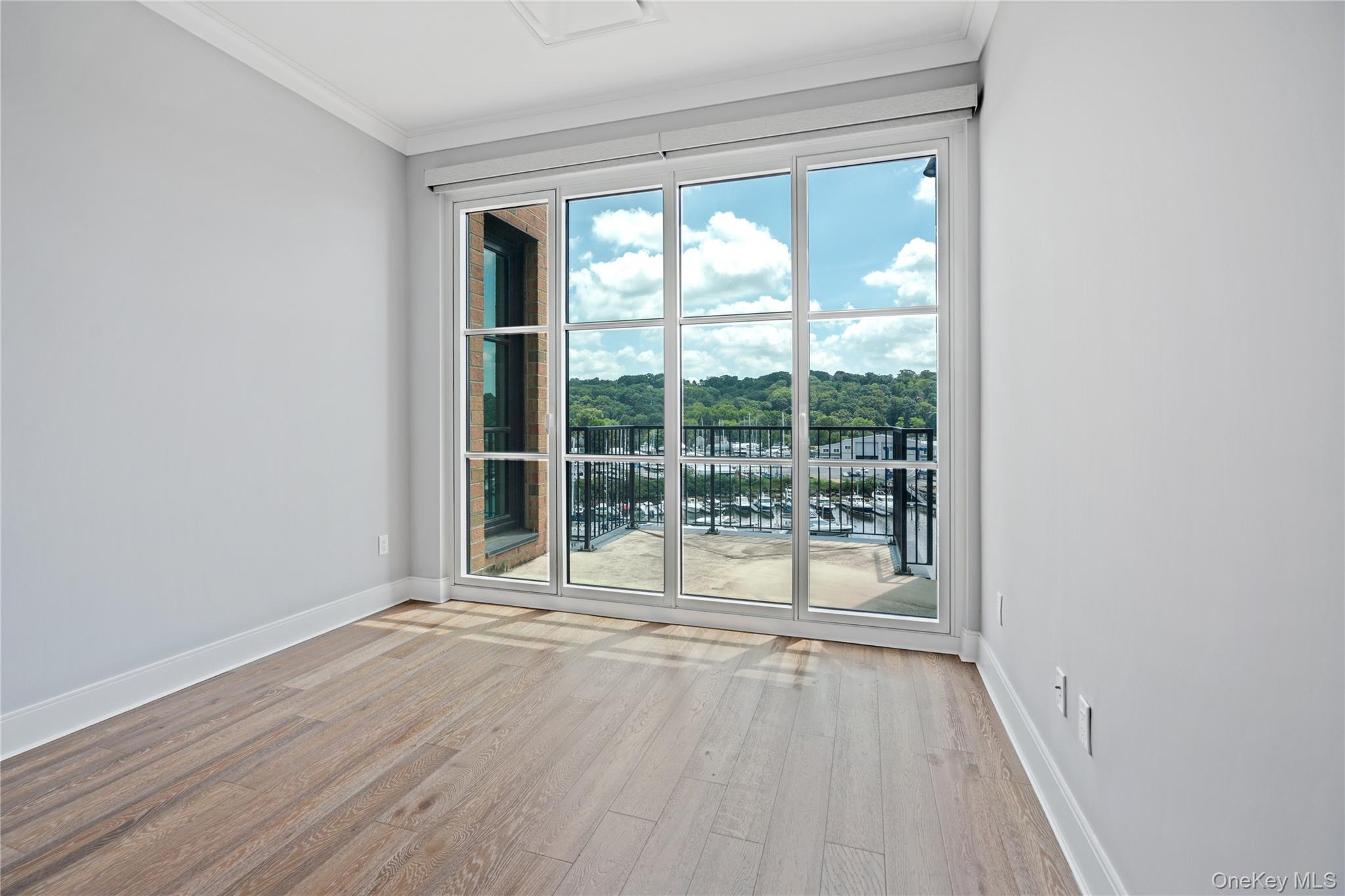 100 Garvies Point Road, Unit 1304 Glen Cove, NY 11542 - Photo 19 of 34 Bedroom with floor to ceiling windows