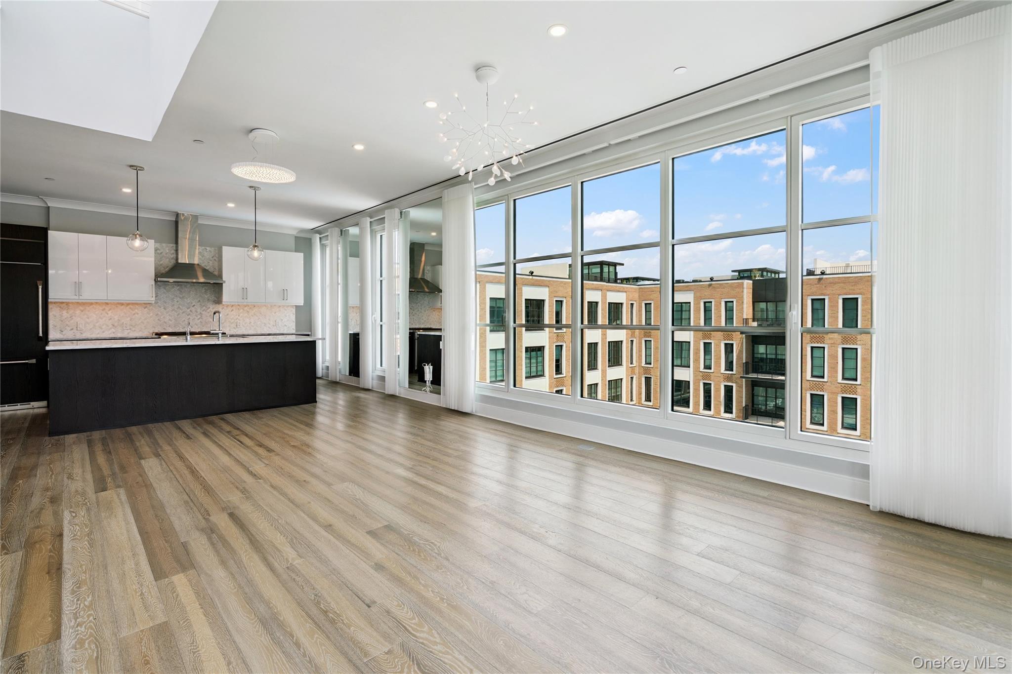 100 Garvies Point Road, Unit 1304 Glen Cove, NY 11542 - Photo 3 of 34 Living room and Kitchen