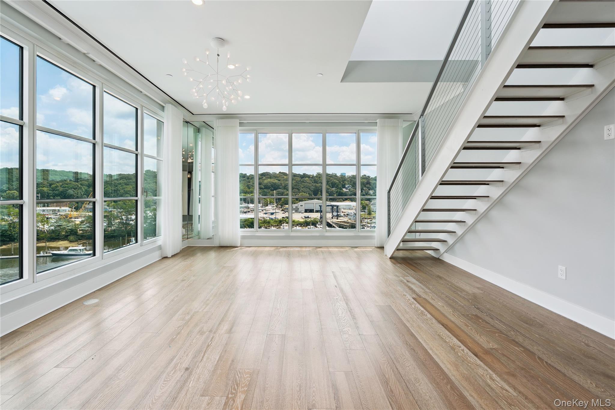 100 Garvies Point Road, Unit 1304 Glen Cove, NY 11542 - Photo 8 of 34 Living room with stairway to rooftop terrace